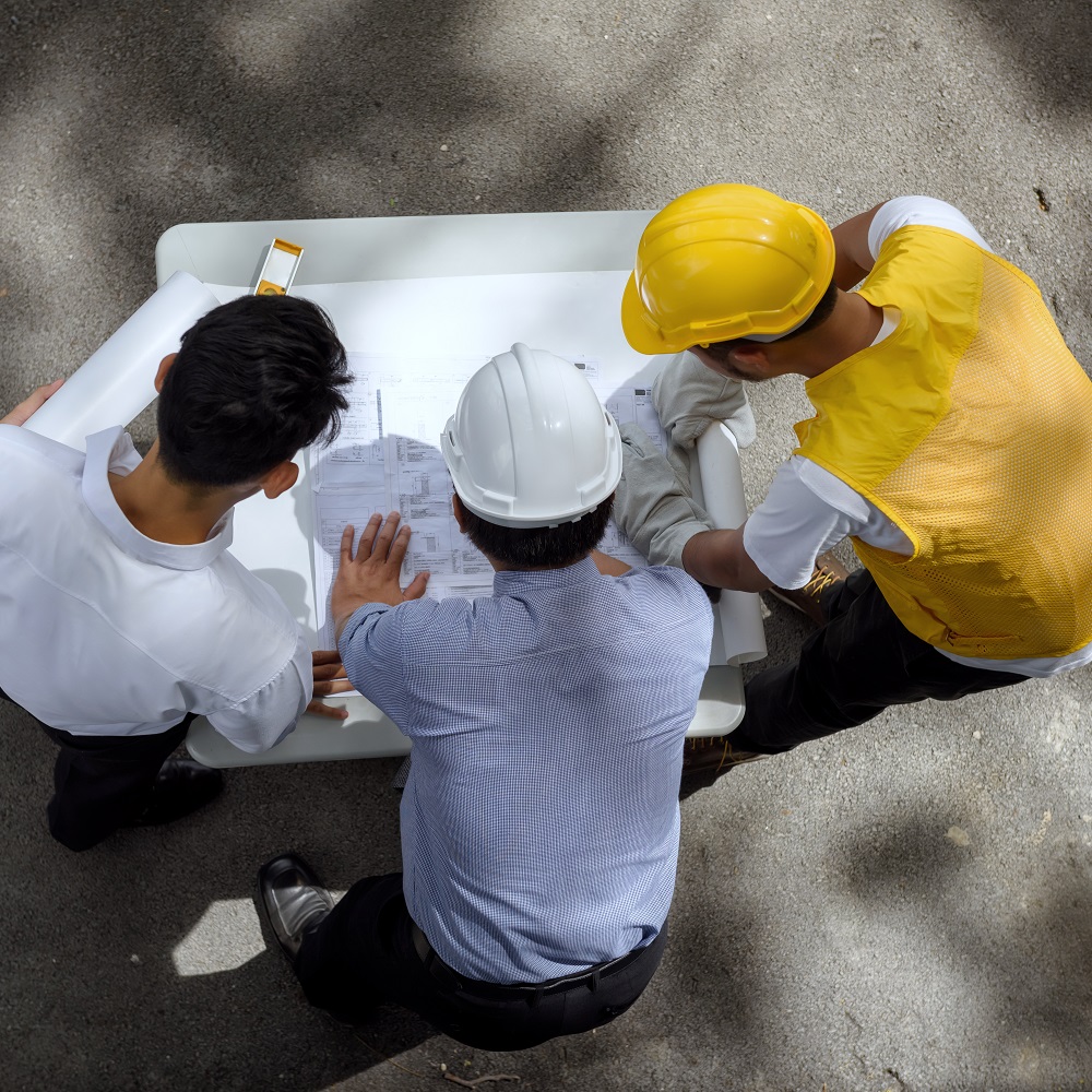 Engineer team discuss project blueprint
